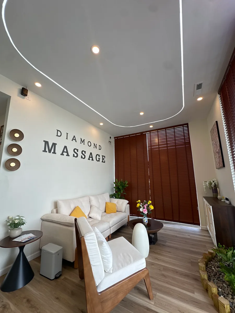 The waiting lounge: DIAMOND MASSAGE painted above a pale sofa with mustard cushions